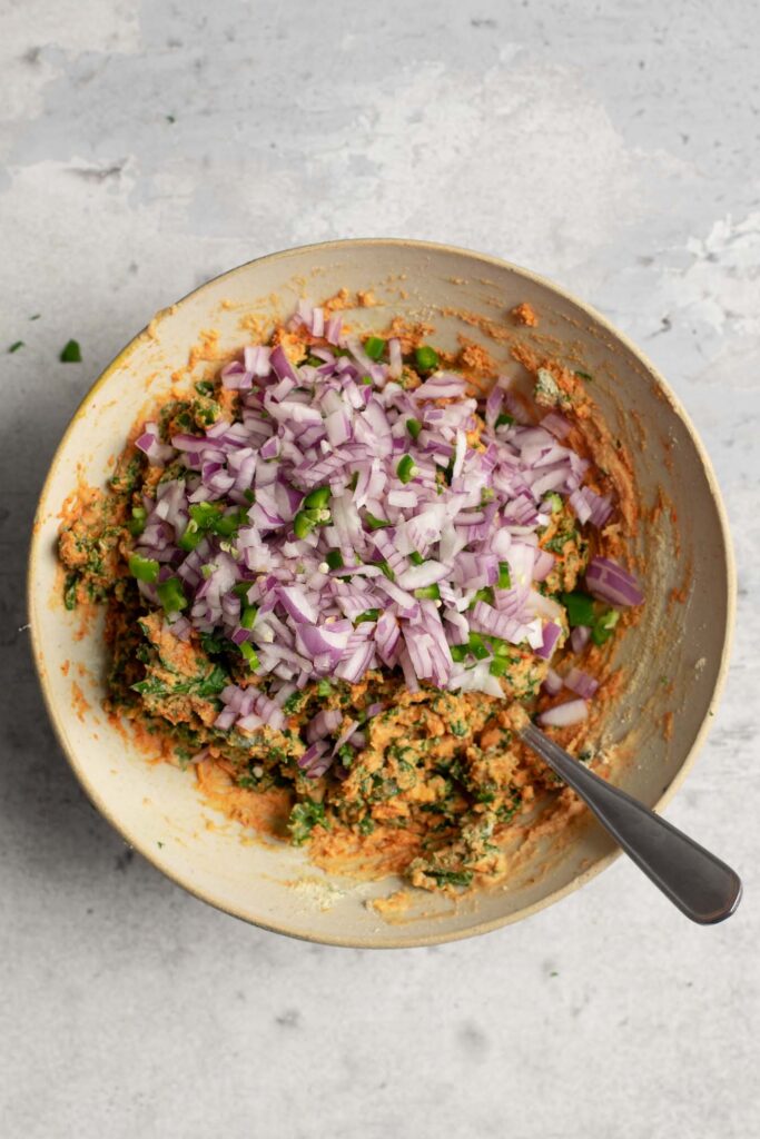 adding onion and chilies into the kale pakora batter