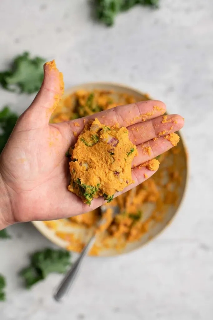shaped pakora batter in the palm of a hand