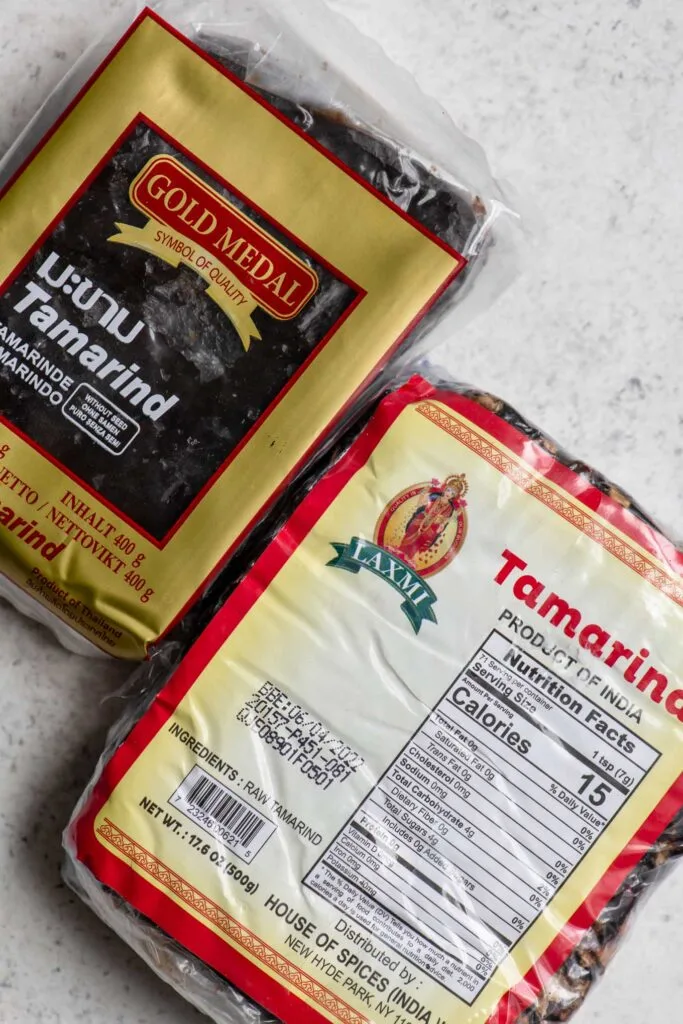 packaged raw tamarind pulp, the package on top is seedless and the one on bottom contains seeds