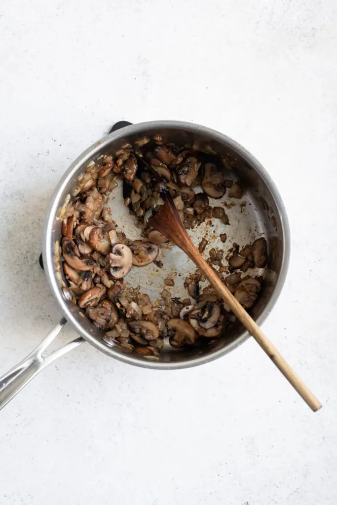 sautéing mushrooms, onion, and garlic in pot