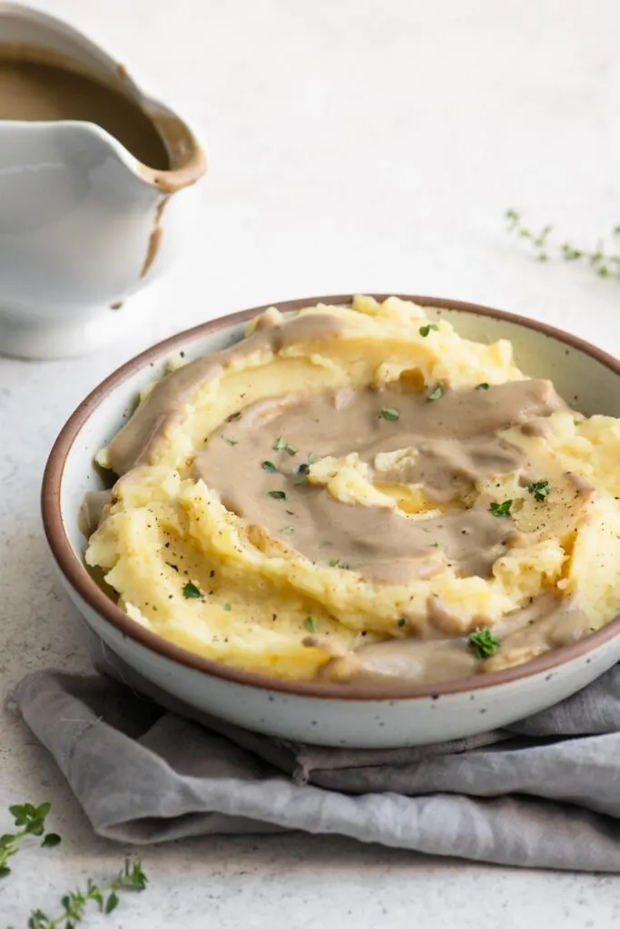 a bowl of mashed potatoes and vegan gravy