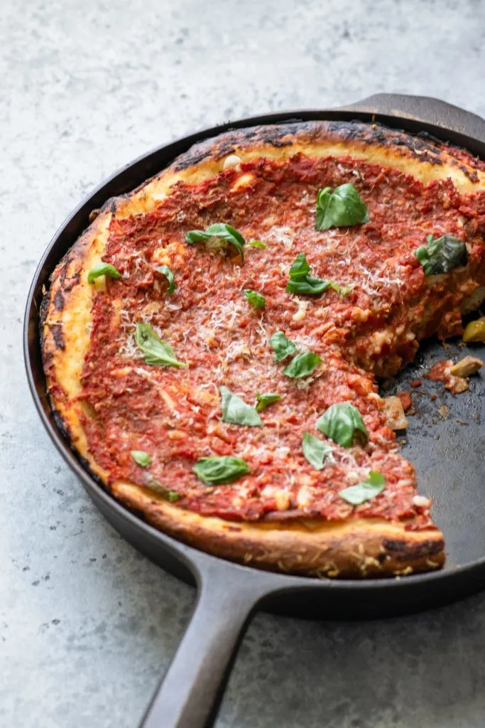 deep dish pizza with a couple of slices missing