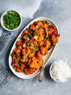 gobi manchurian served on an oval platter with a side of basmati rice