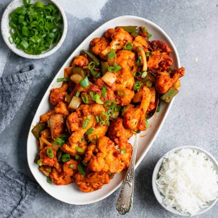 gobi manchurian served on an oval platter with a side of basmati rice