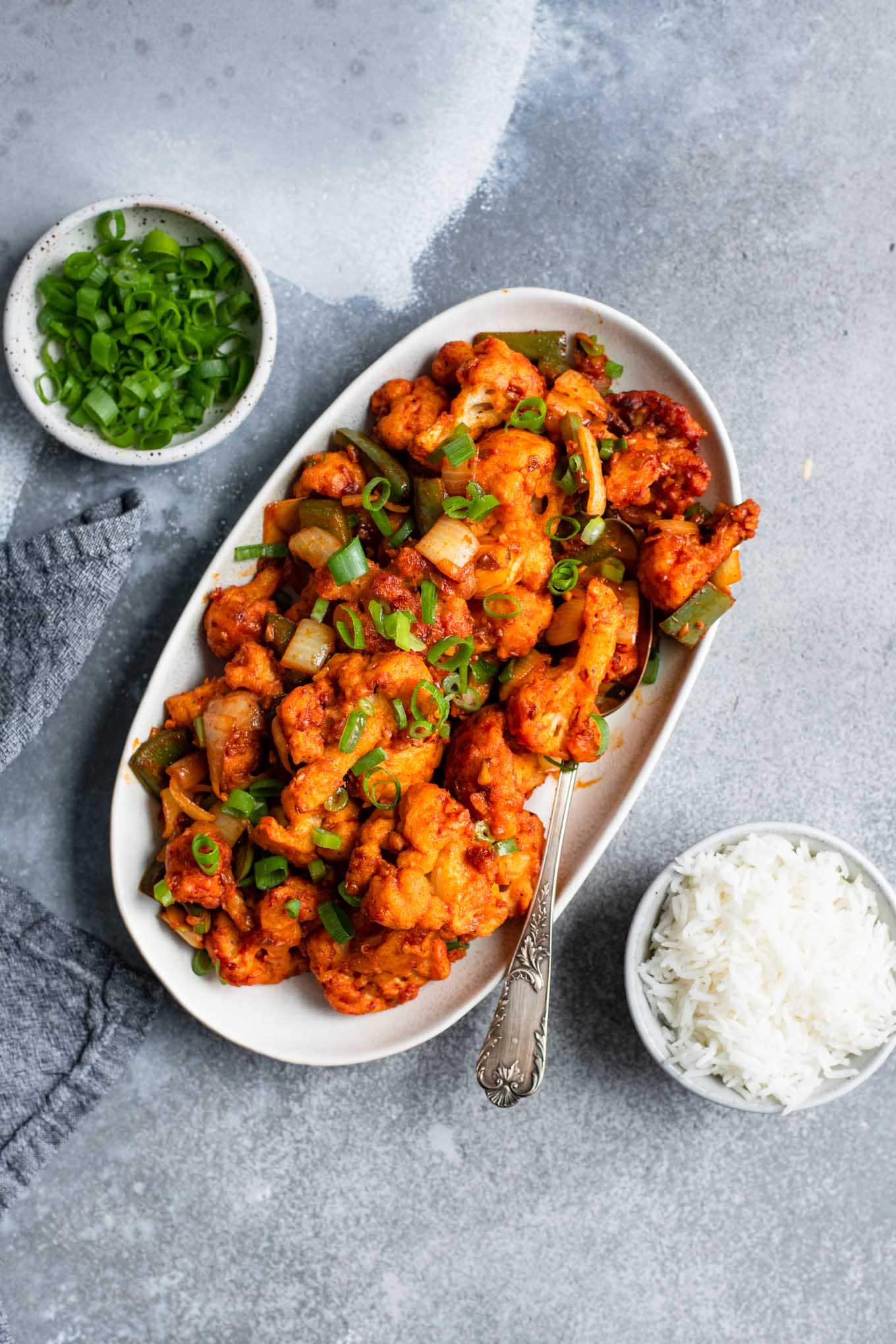 gobi manchurian served on an oval platter with a side of basmati rice