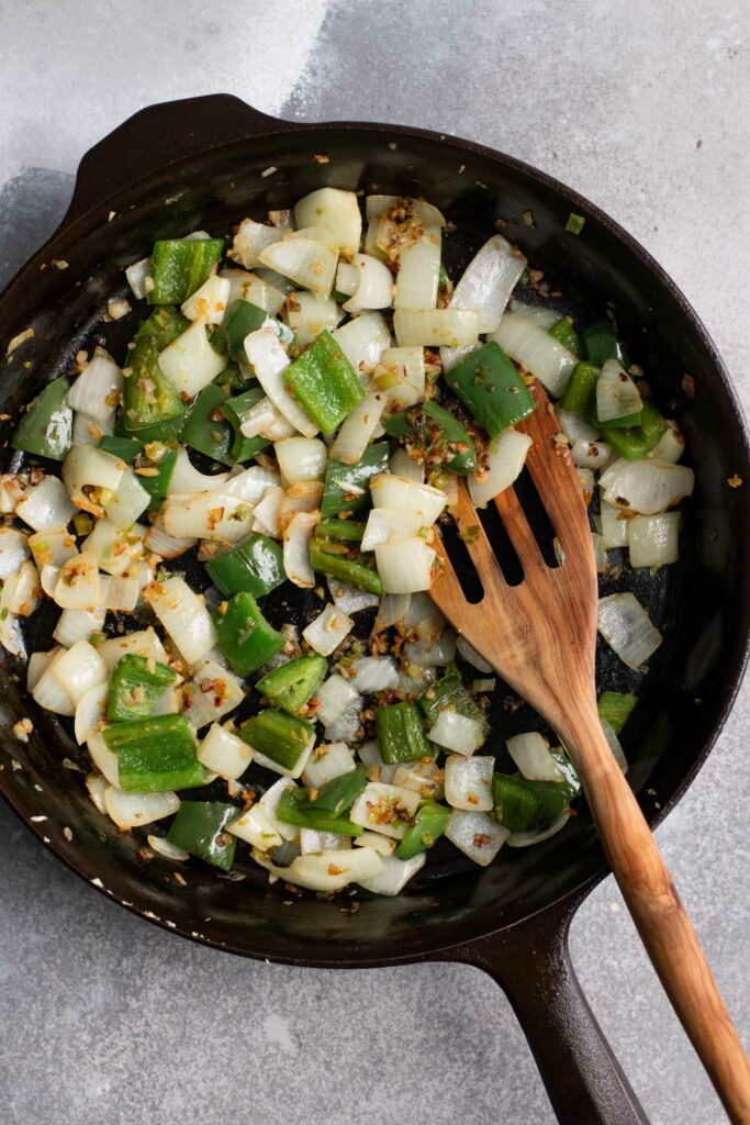 cooked garlic, ginger, scallion, onion, and bell pepper in a skillet for manchurian sauce