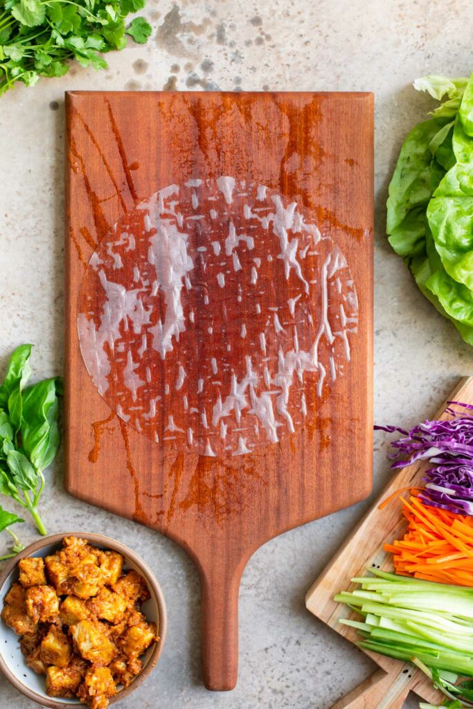 dampened rice paper wrap on damp cutting board