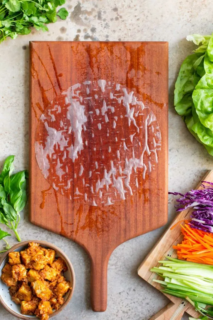dampened rice paper wrap on damp cutting board