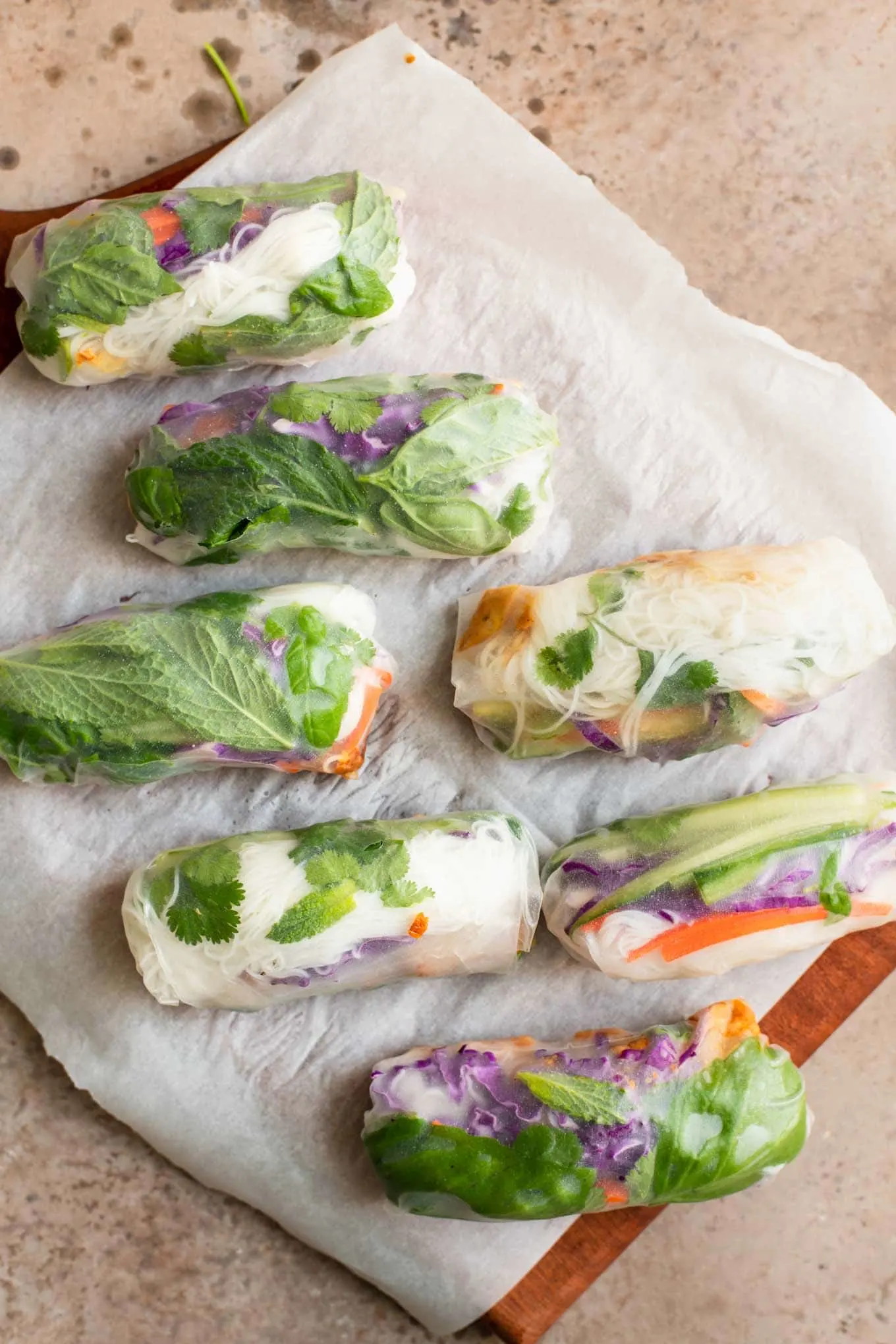 spring rolls on a parchment lined cutting board