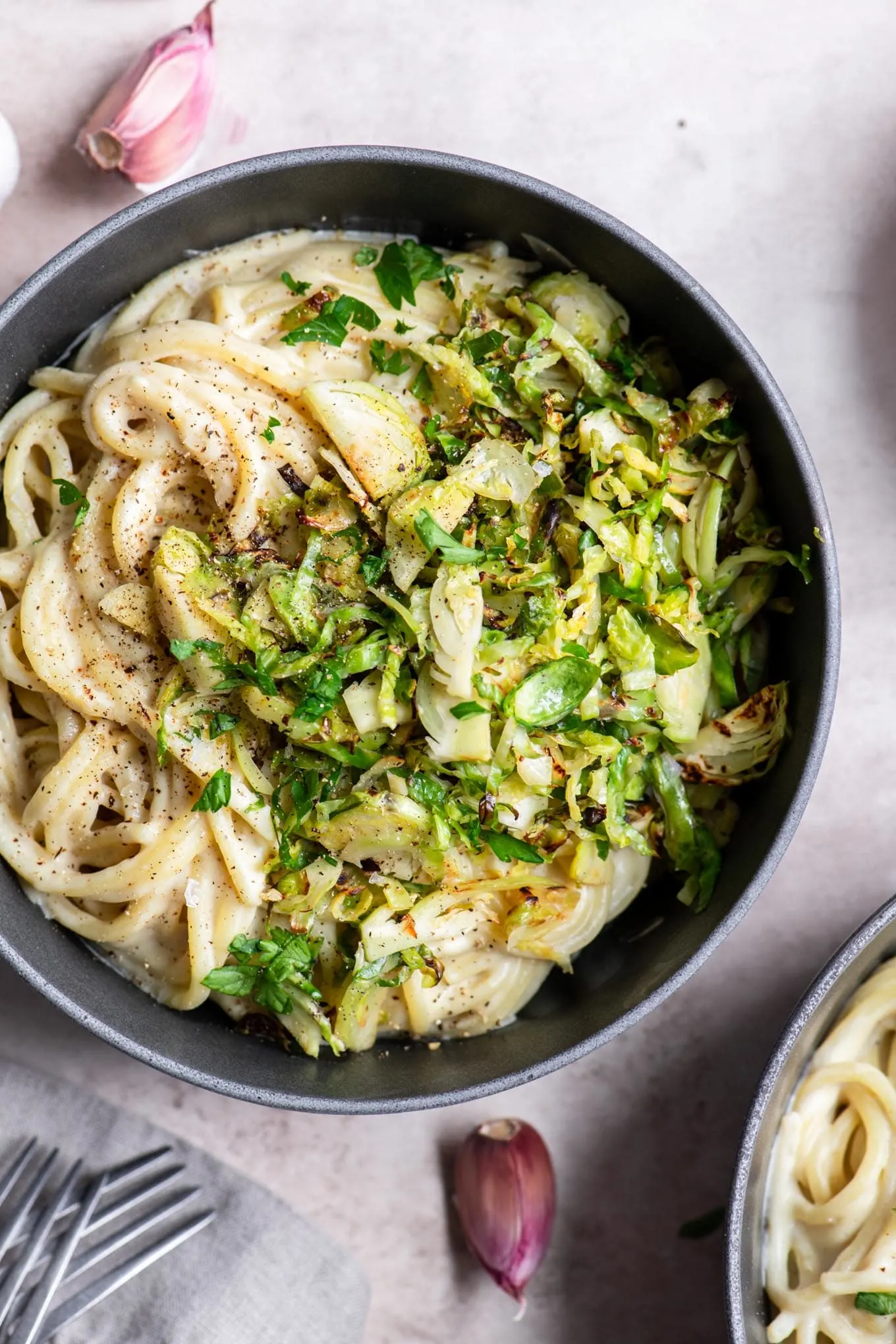 vegan creamy garlic spaghetti with Brussels sprouts in a bowl