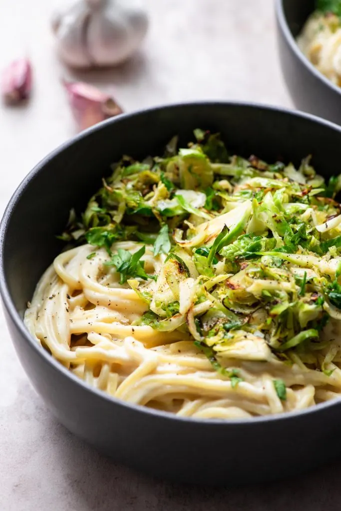 side view of the served creamy garlic pasta with brussels sprouts