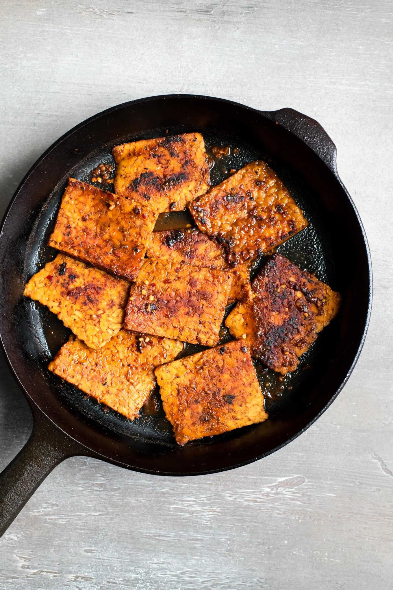 The corned tempeh in the skillet after the marinade is added