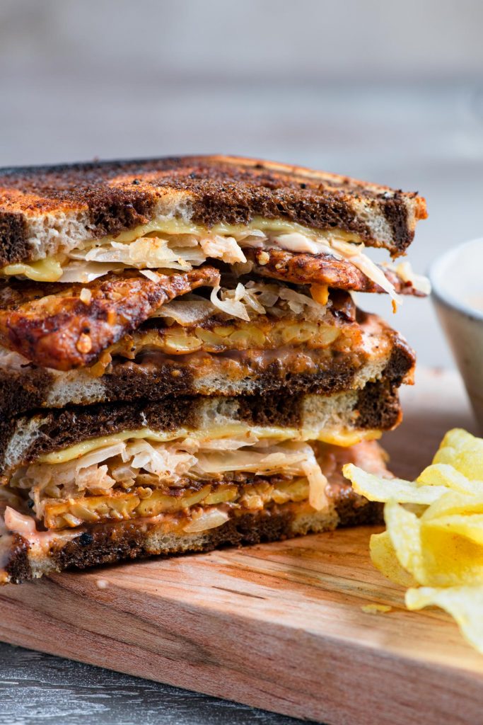 close up of the vegan reuben sandwich, cut in half