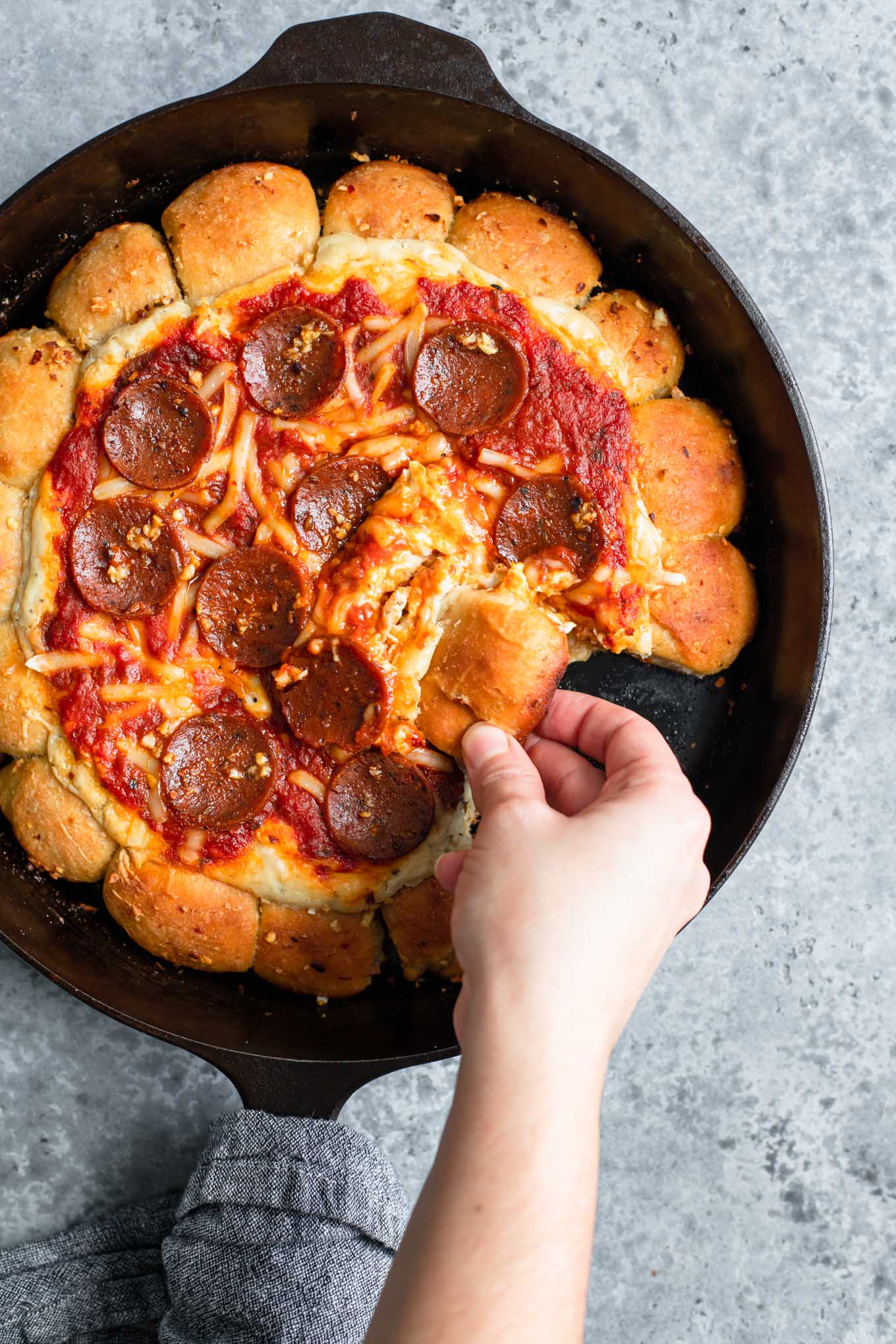 scooping up a bite of vegan skillet pizza dip