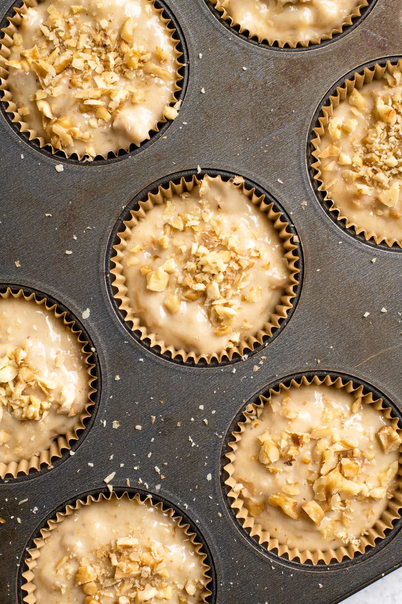 muffin tin filled with banana bread batter