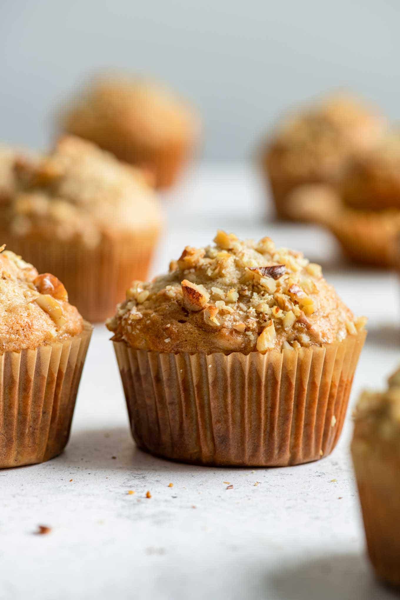 side view of banana muffins topped with walnuts