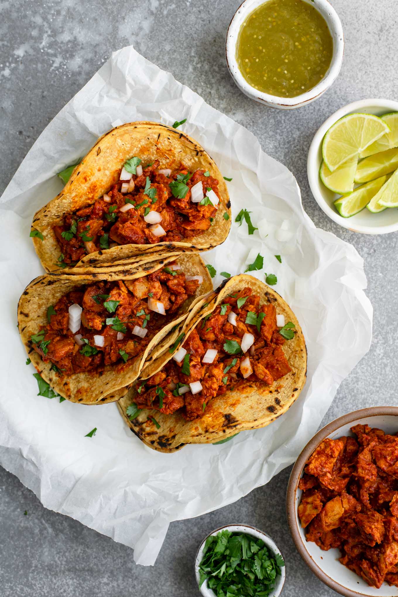 vegan barbacoa tacos topped with minced onion and cilantro