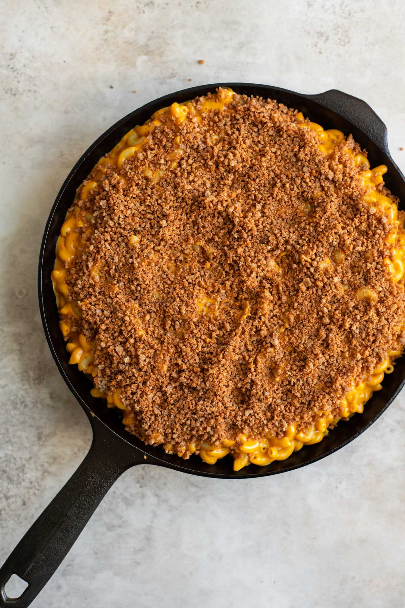 injera crumb topped berbere mac and cheese before baking