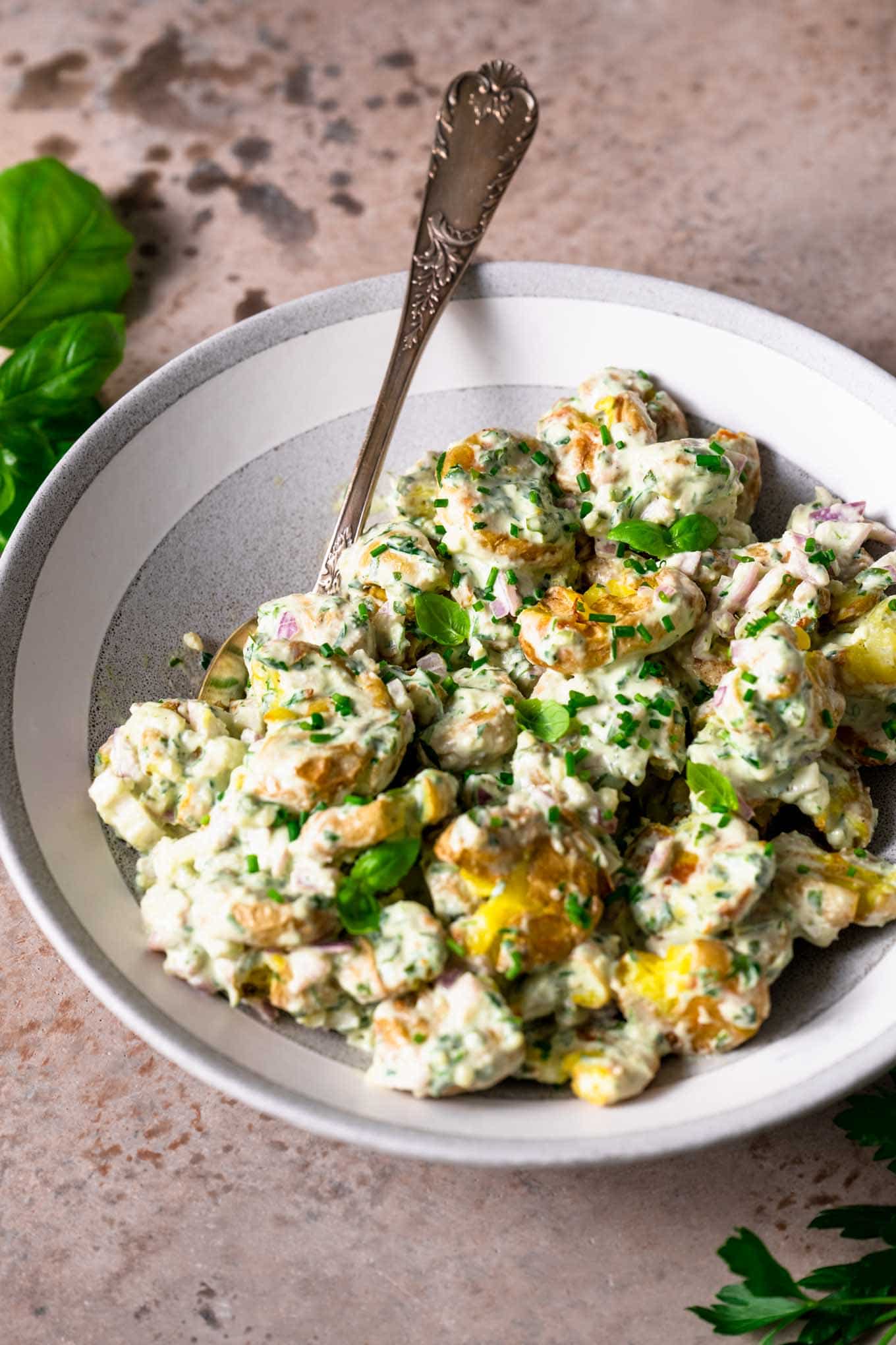 smashed potato herbed salad in serving bowl