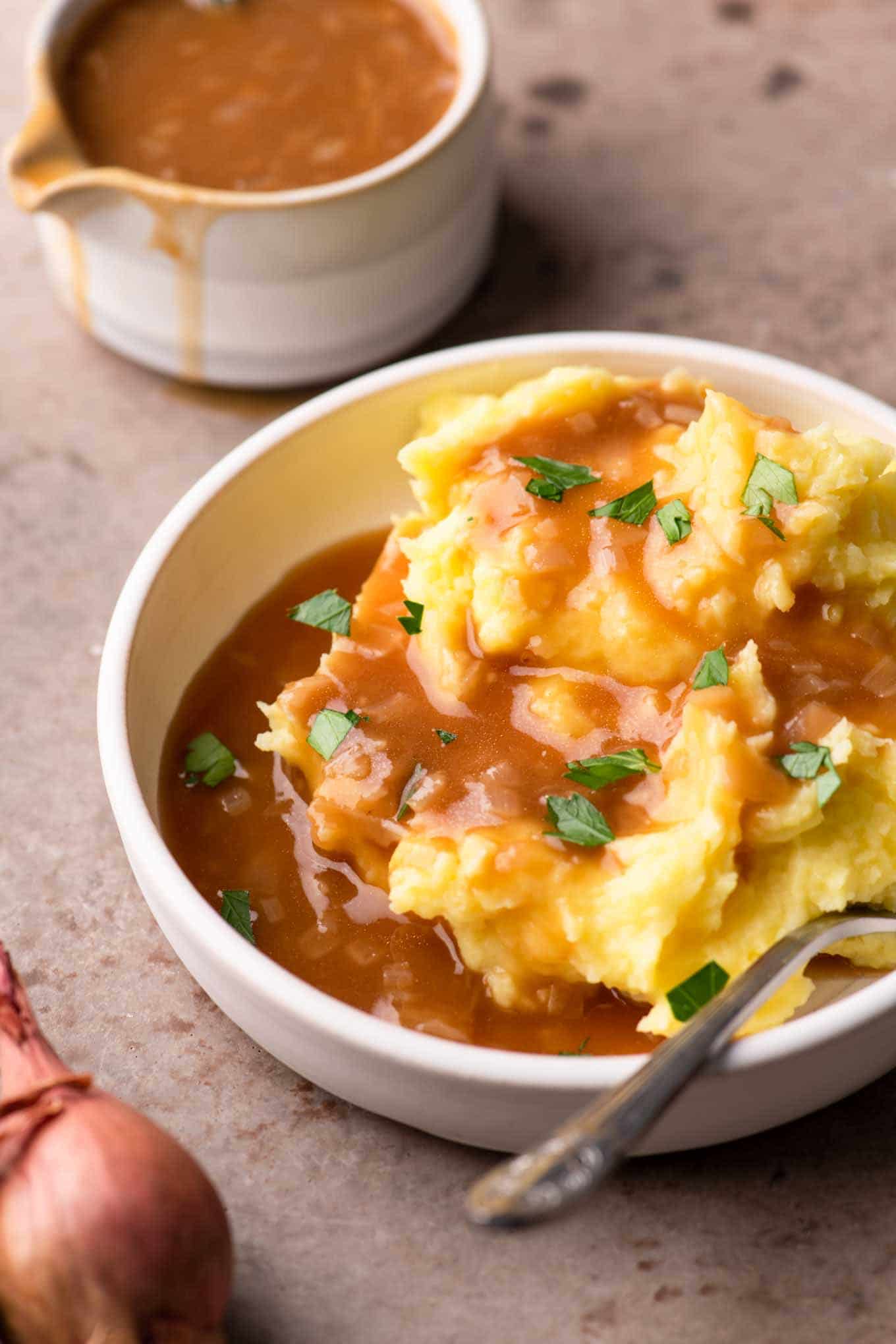 mashed potatoes in a bowl topped with gravy