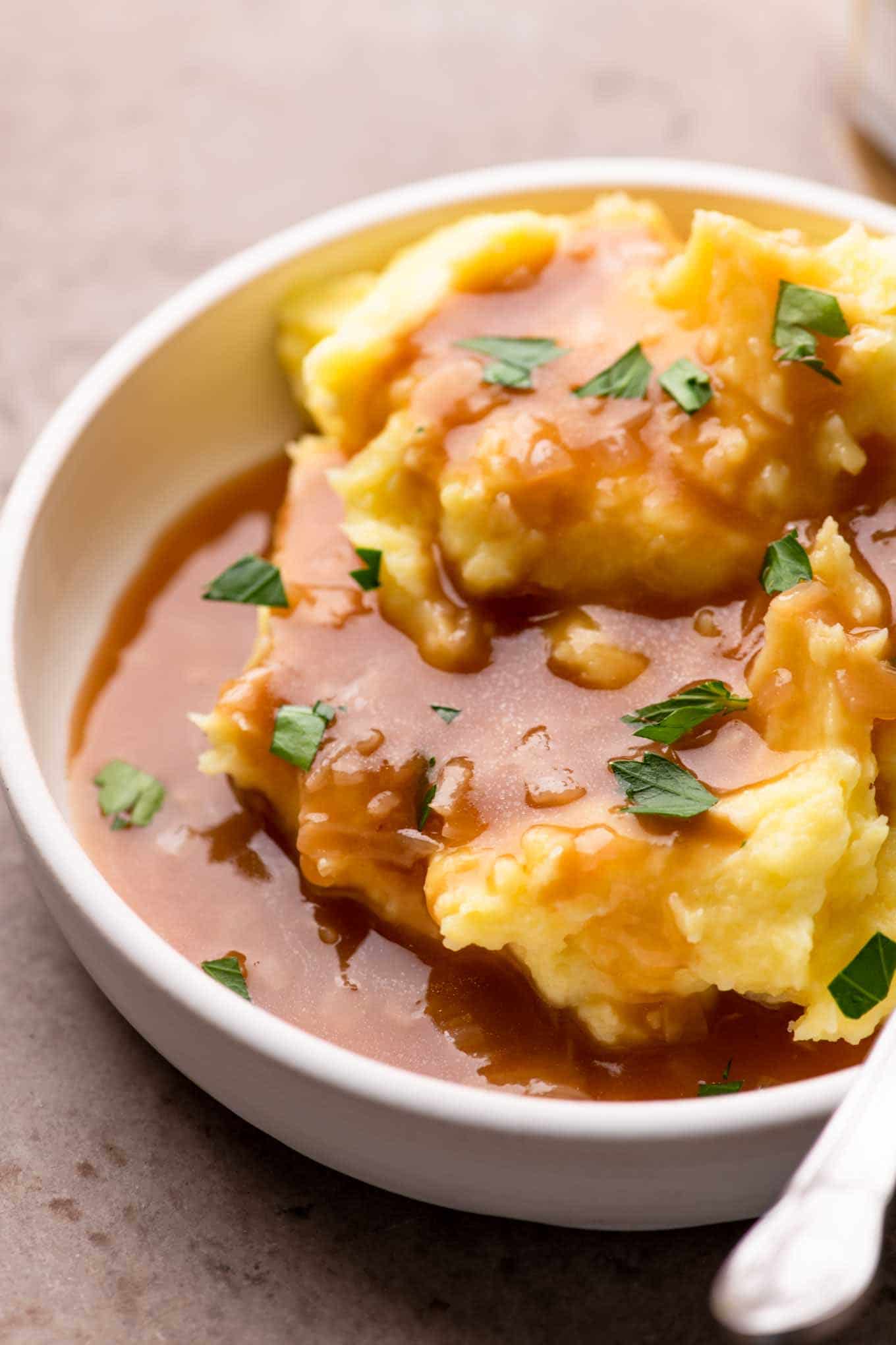 close up of gravy poured over mashed potatoes