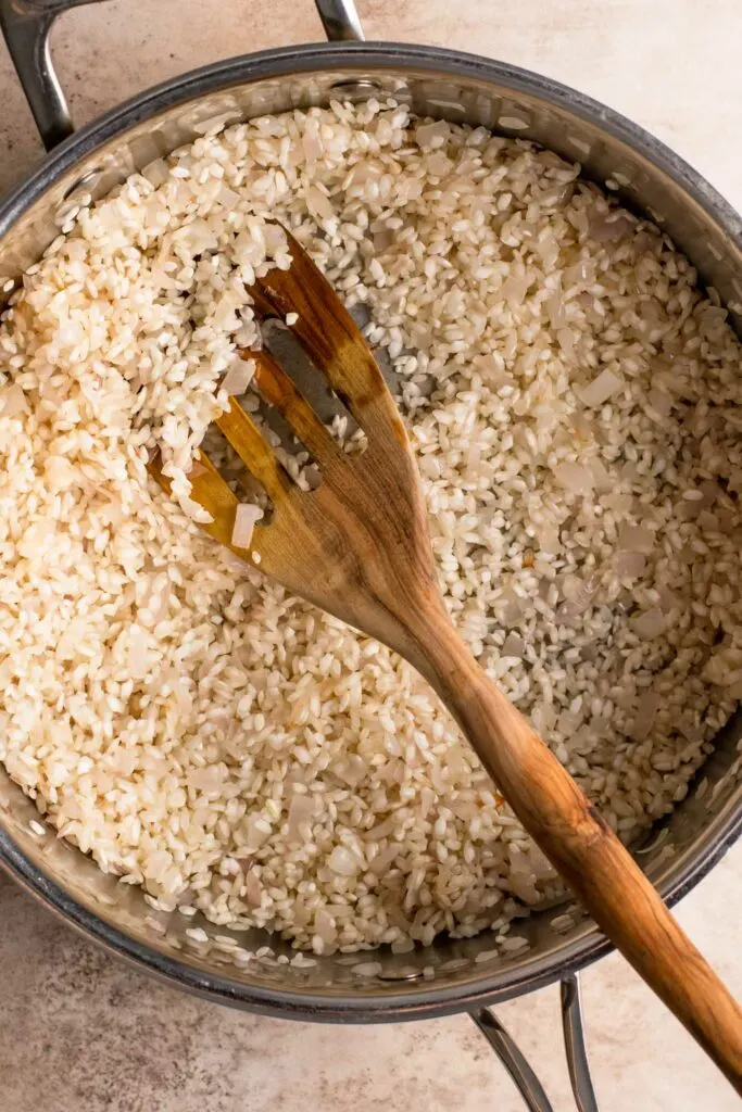 rice and onion toasted in vegan butter in pot