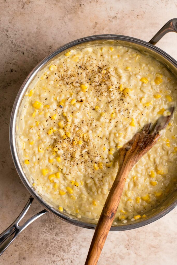finished sweet corn risotto in pot with cashew cream and corn added