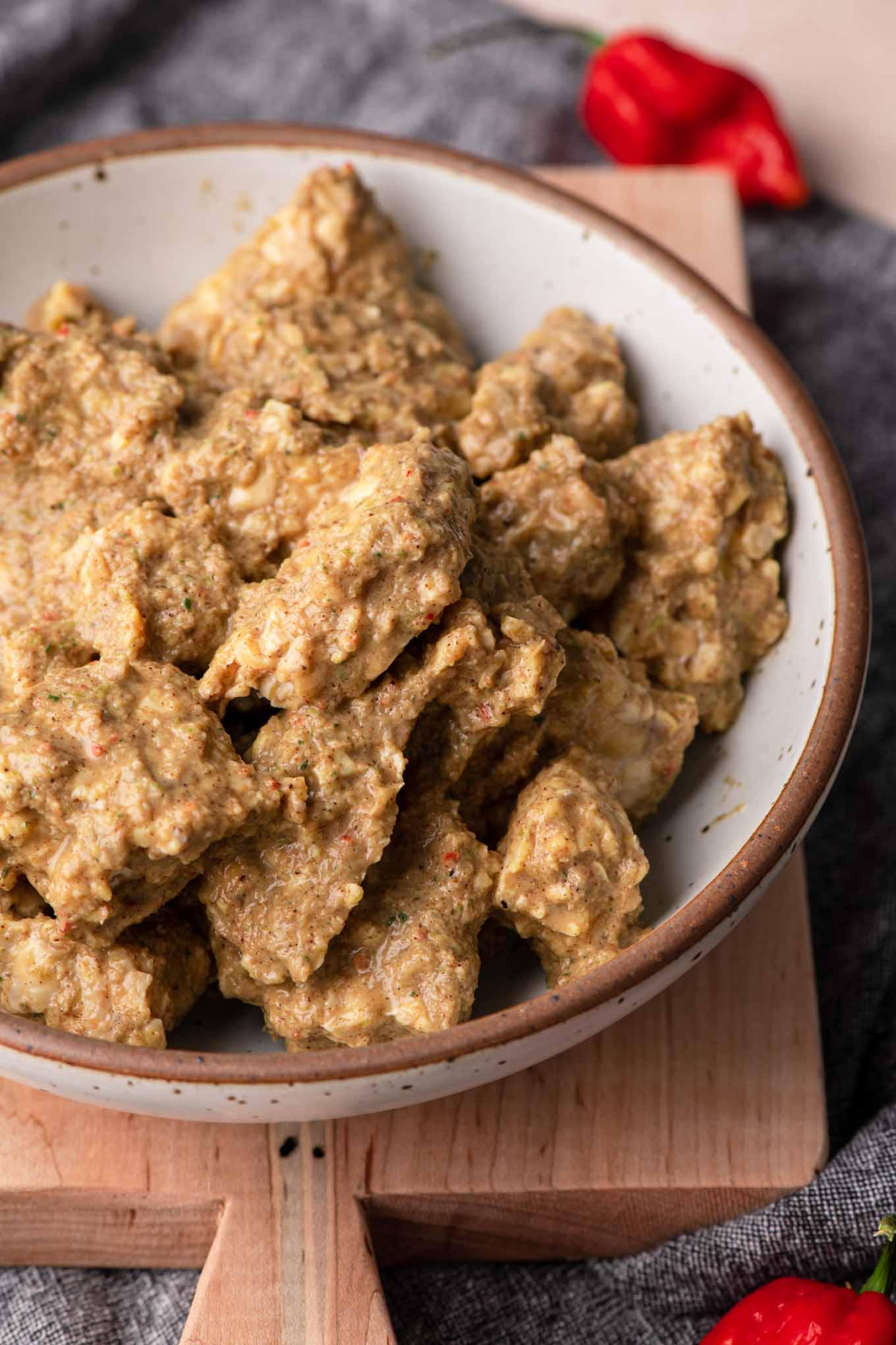 tempeh marinated in jerk sauce in a large bowl