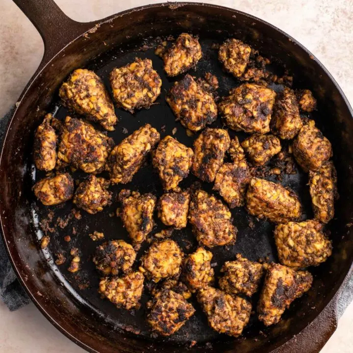 jerk tempeh cooked in a cast iron skillet