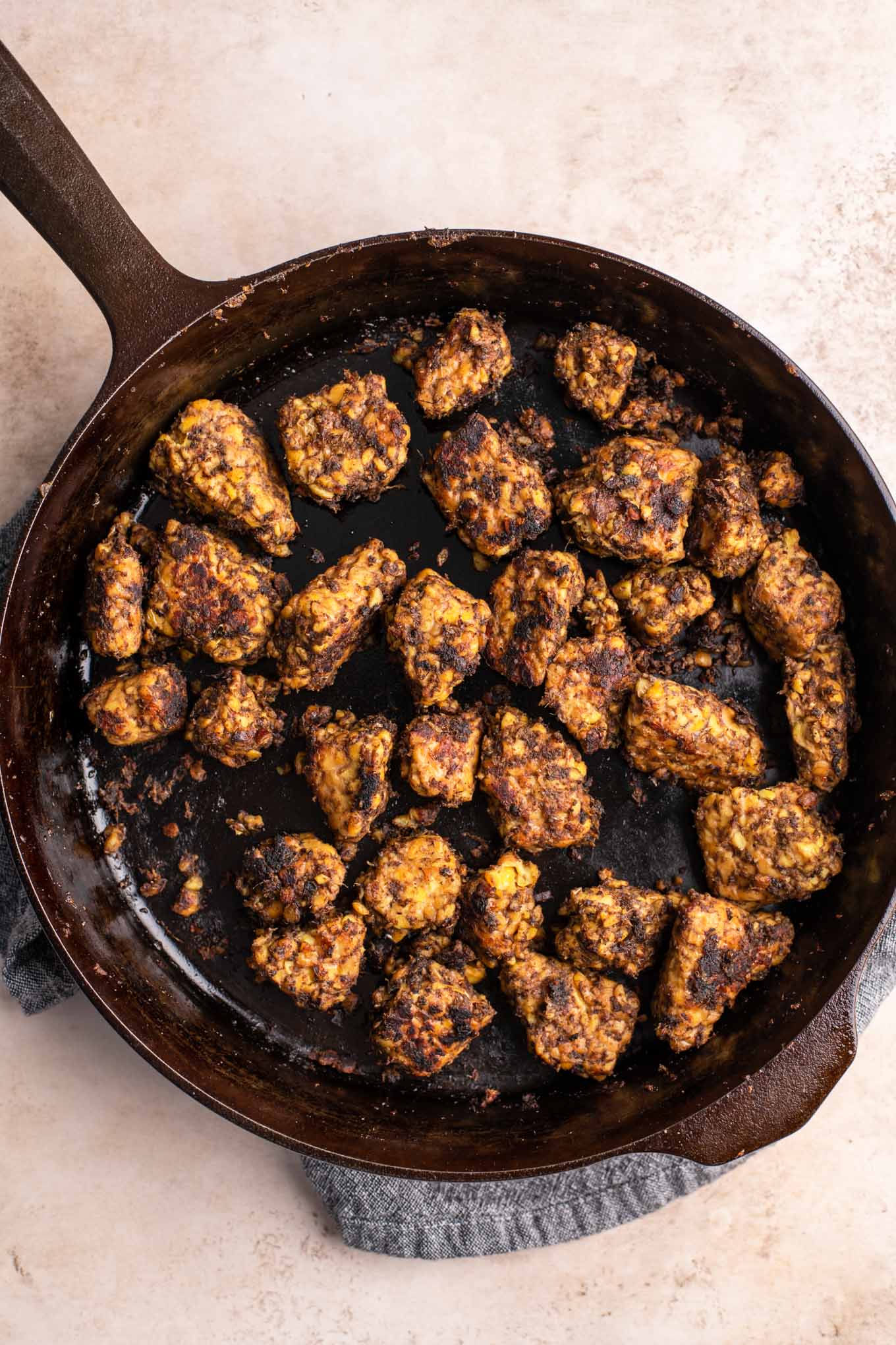 jerk tempeh cooked in a cast iron skillet