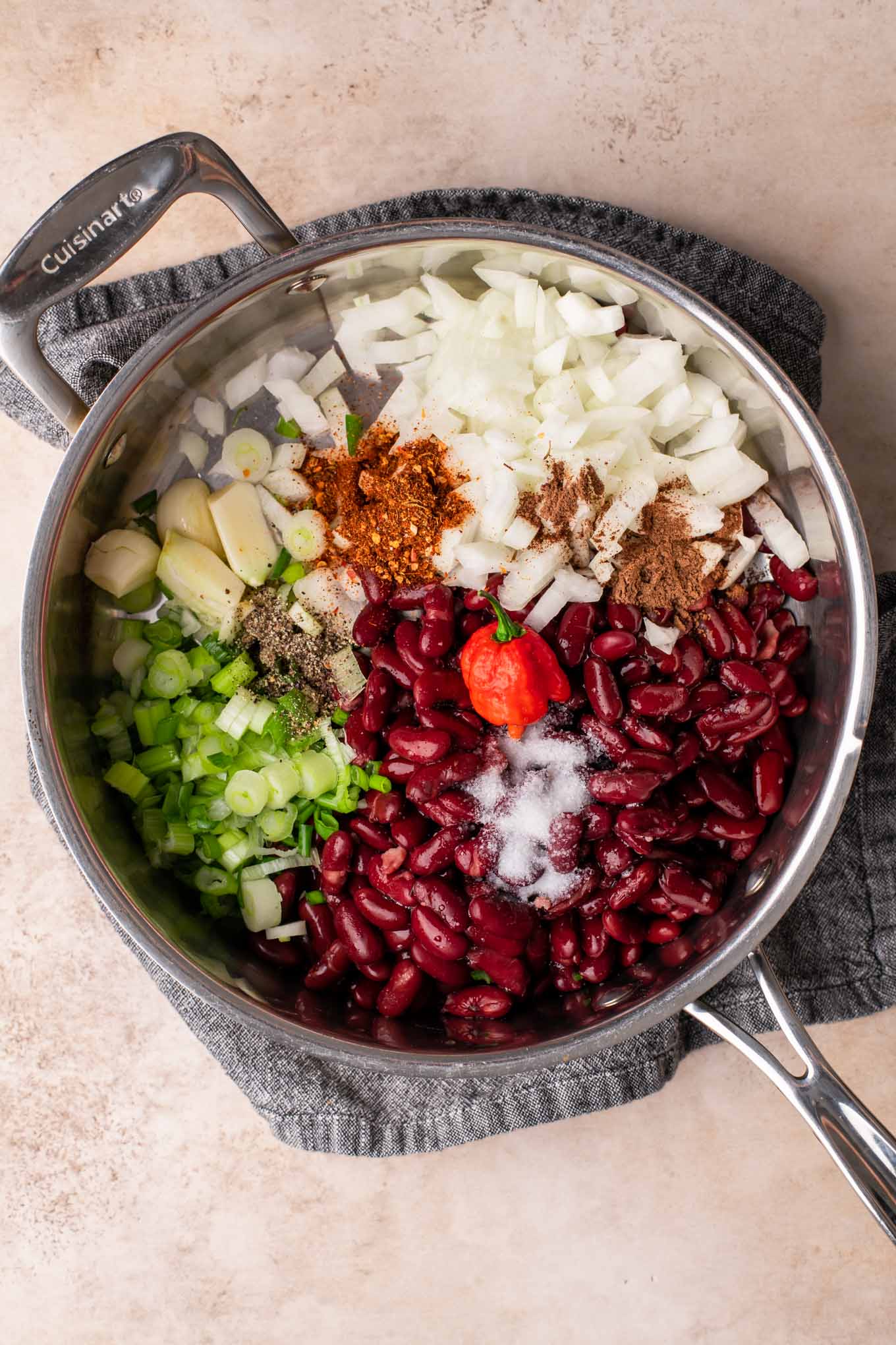 beans, onion, garlic, spices, and chili pepper in a pot