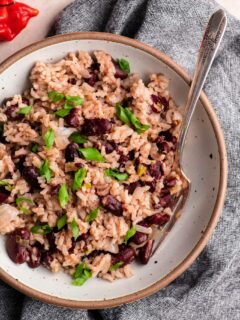 jamaican red rice and beans in a bowl garnished with scallions