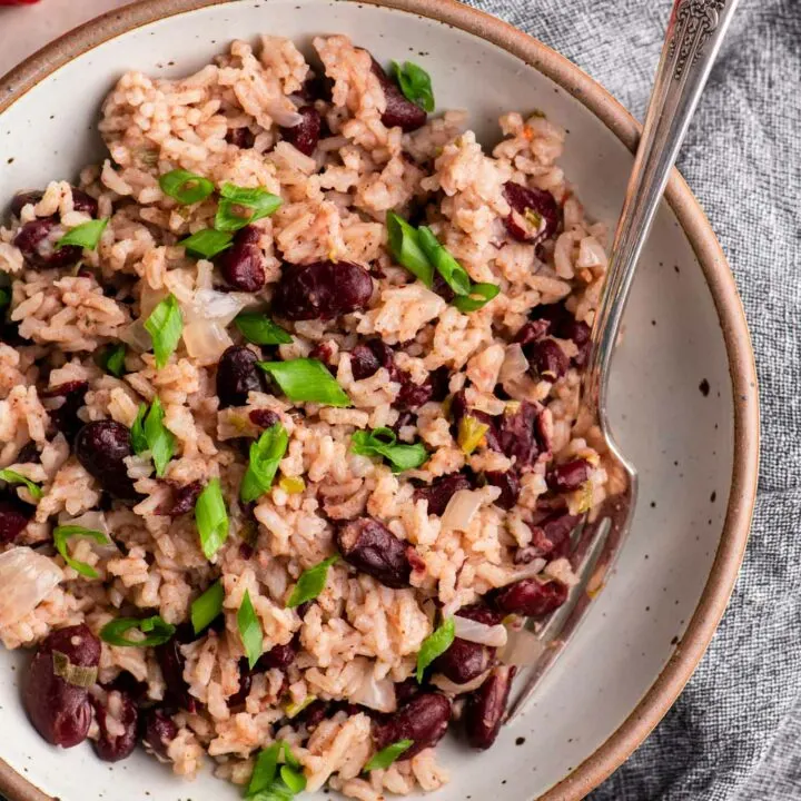 jamaican red rice and beans in a bowl garnished with scallions