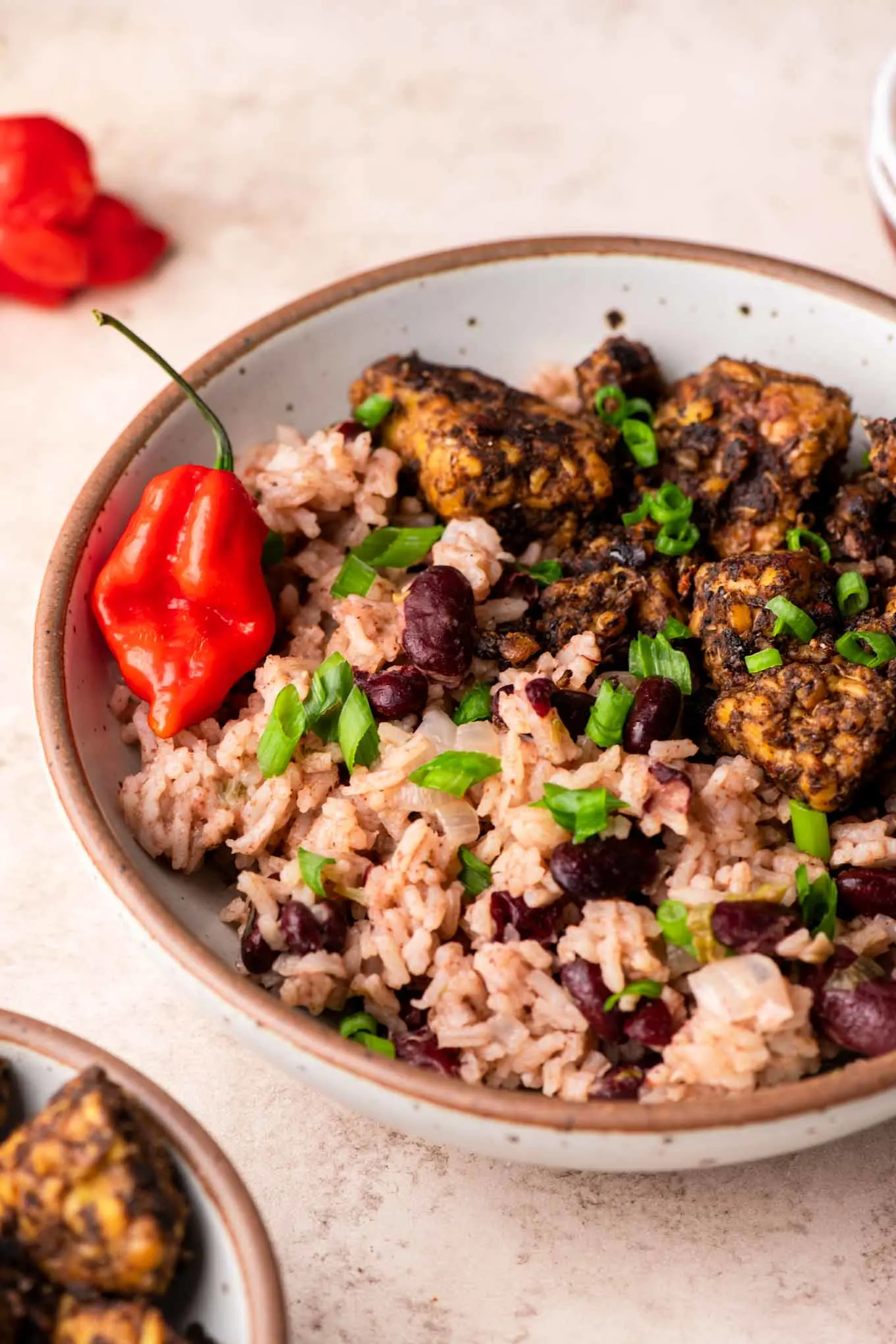 jamaican red beans and rice in a bowl with jerk tempeh