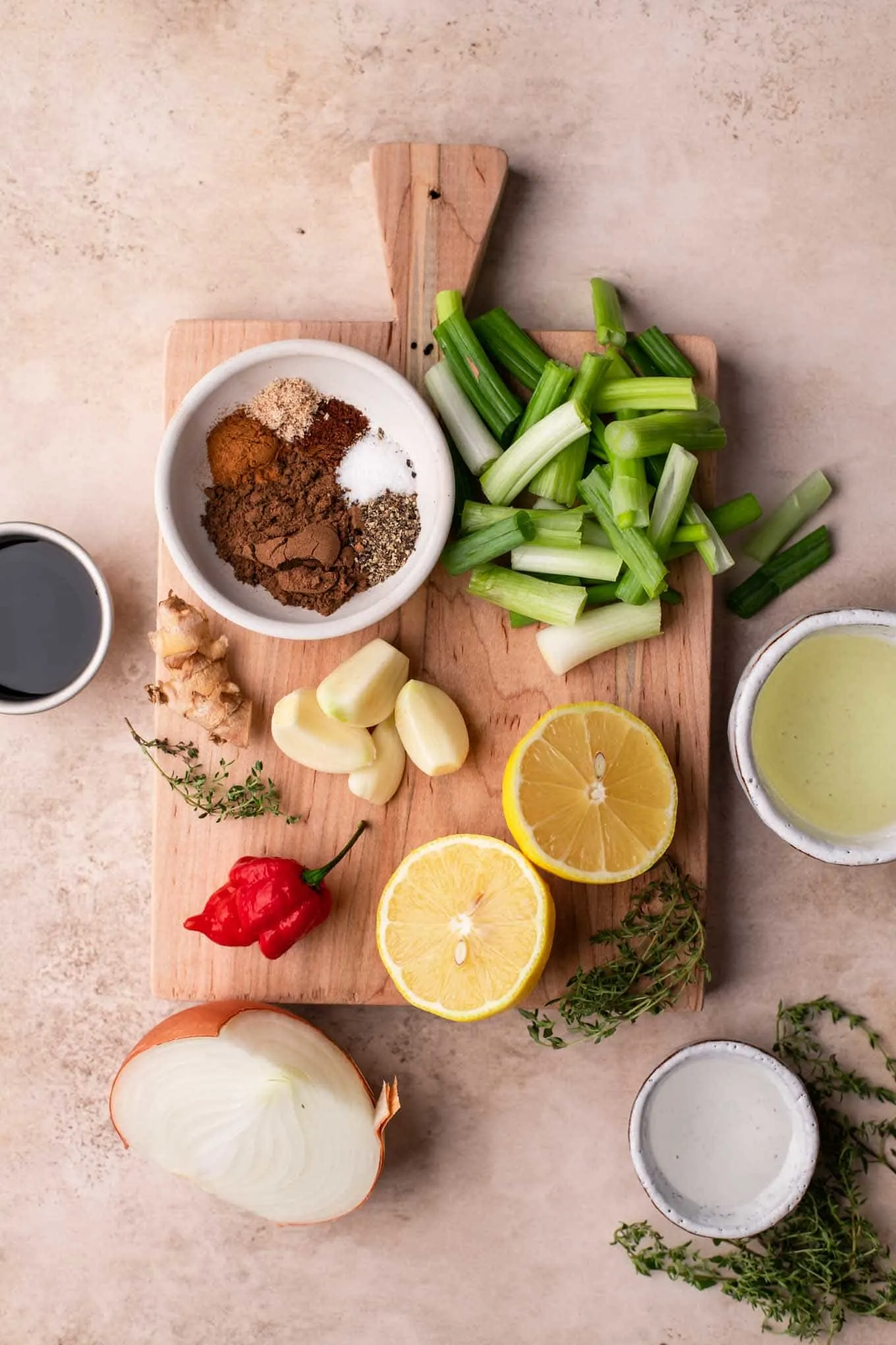 ingredients for jamaican jerk sauce measured out on a cutting board