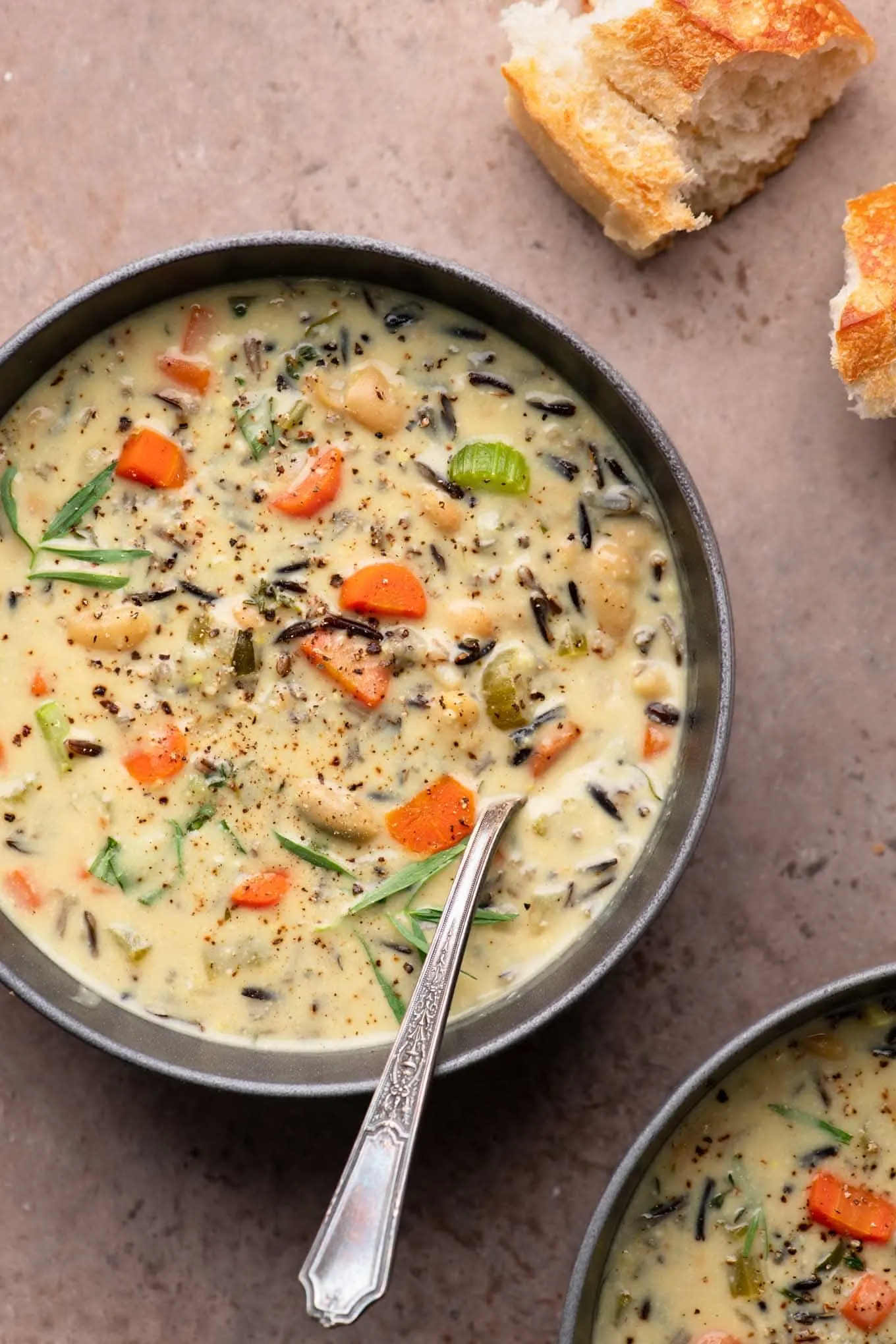 soup in bowls served with torn baguette