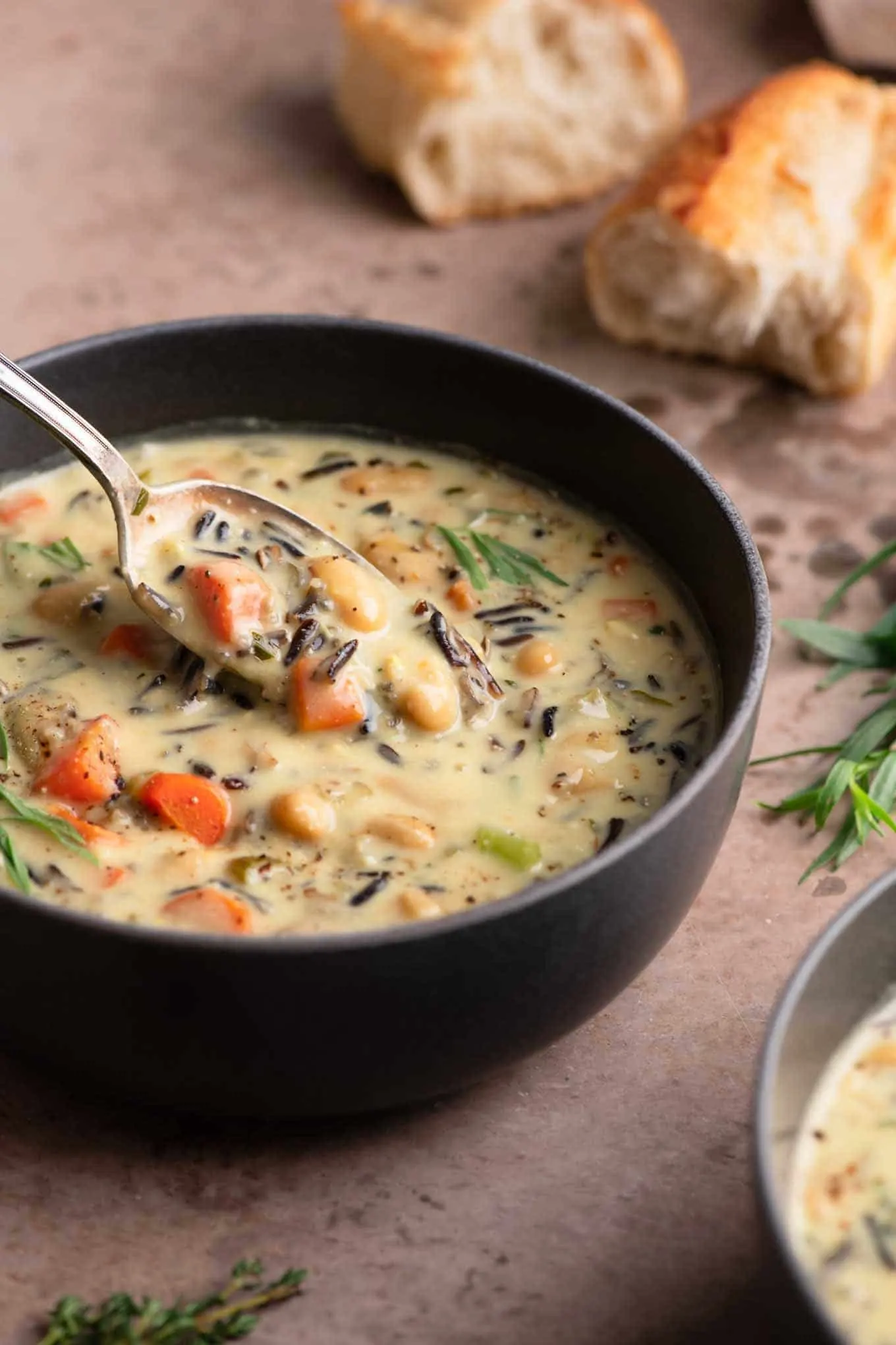 taking a spoonful of the vegan white bean wild rice soup