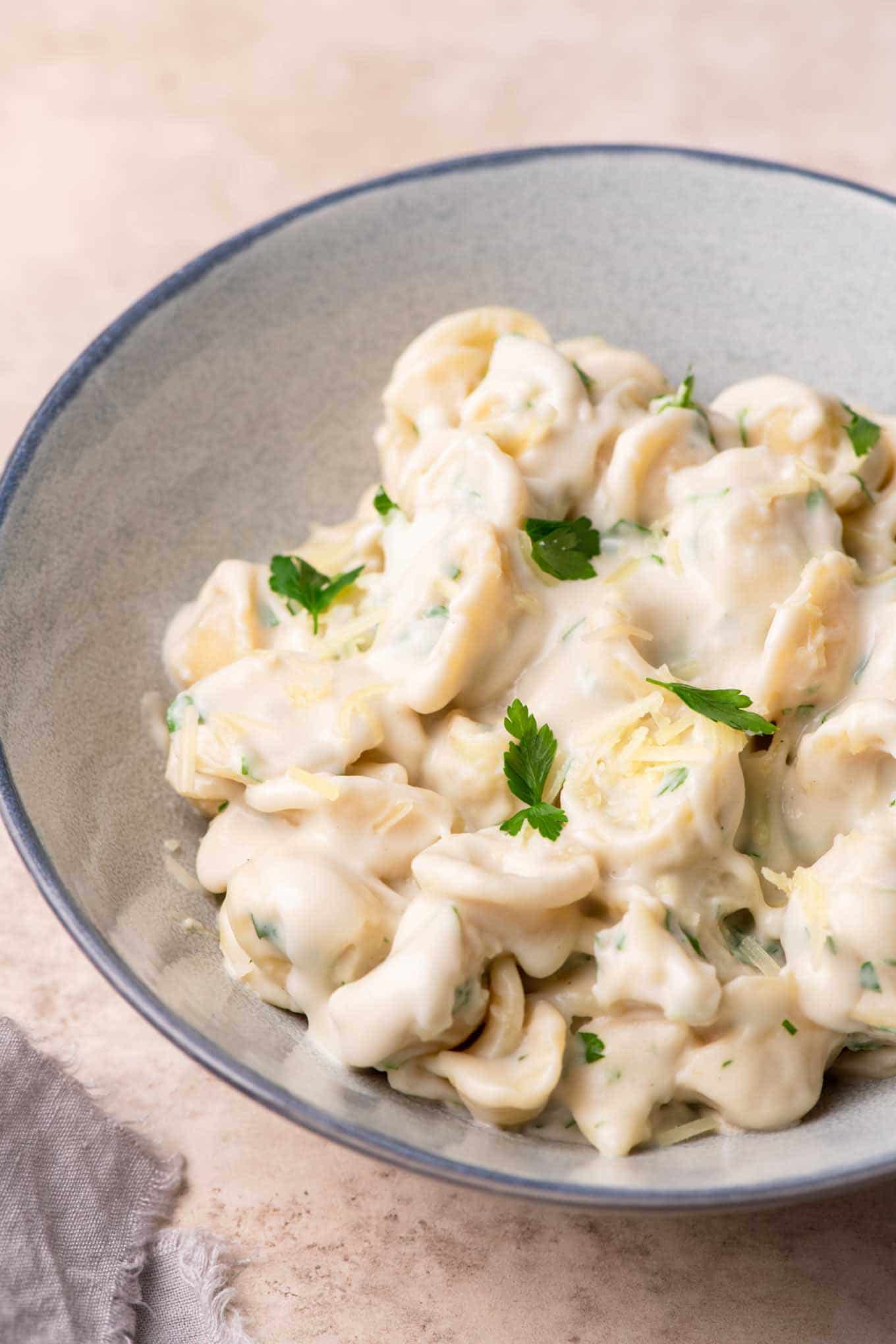 side view of creamy garlic noodles in a bowl